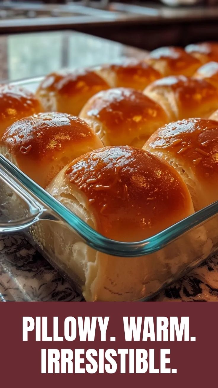 Soft dinner rolls with a golden-brown top, fresh from the oven.