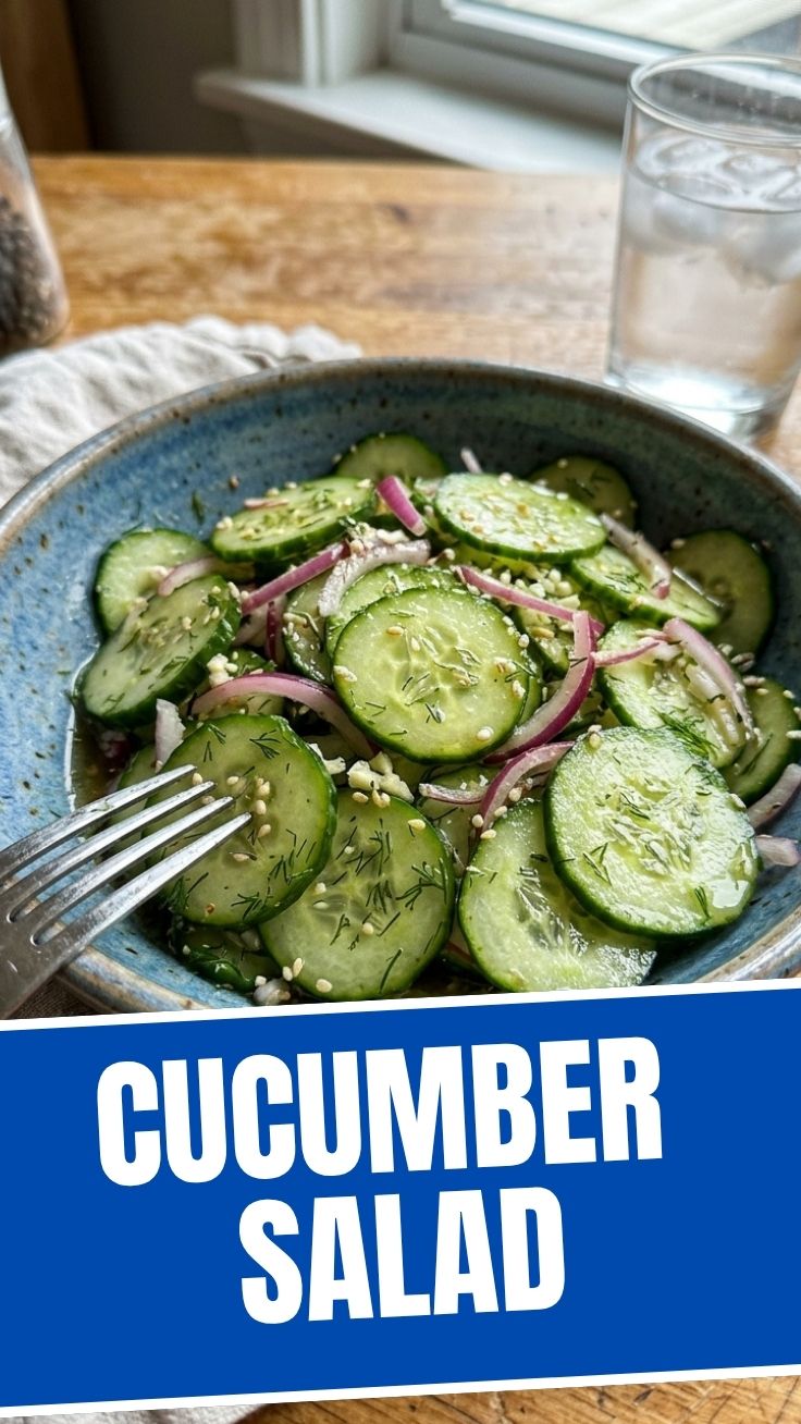 A refreshing cucumber salad with dill and onions in a glass bowl.
